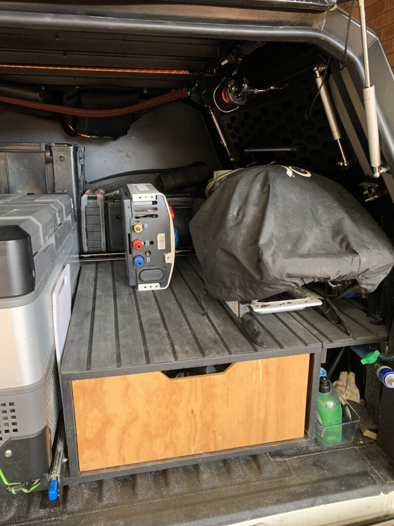 Dual cab ute tub canopy storage setup ideas for touring with a truck bed. Storage ideas for Weber BBQ baby Q with quick connect.