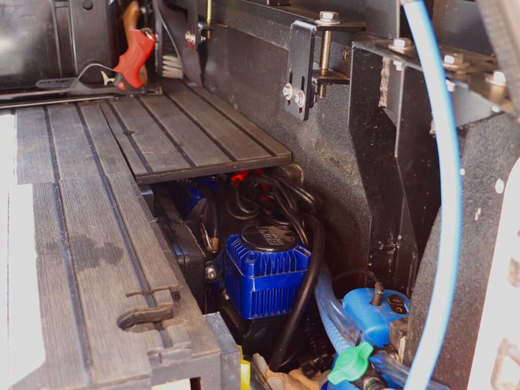 Smart ute storage setup ideas for touring with a ute tub or truck bed. The storage ideas of the canopy maximise space. False floor storage for air compressor.